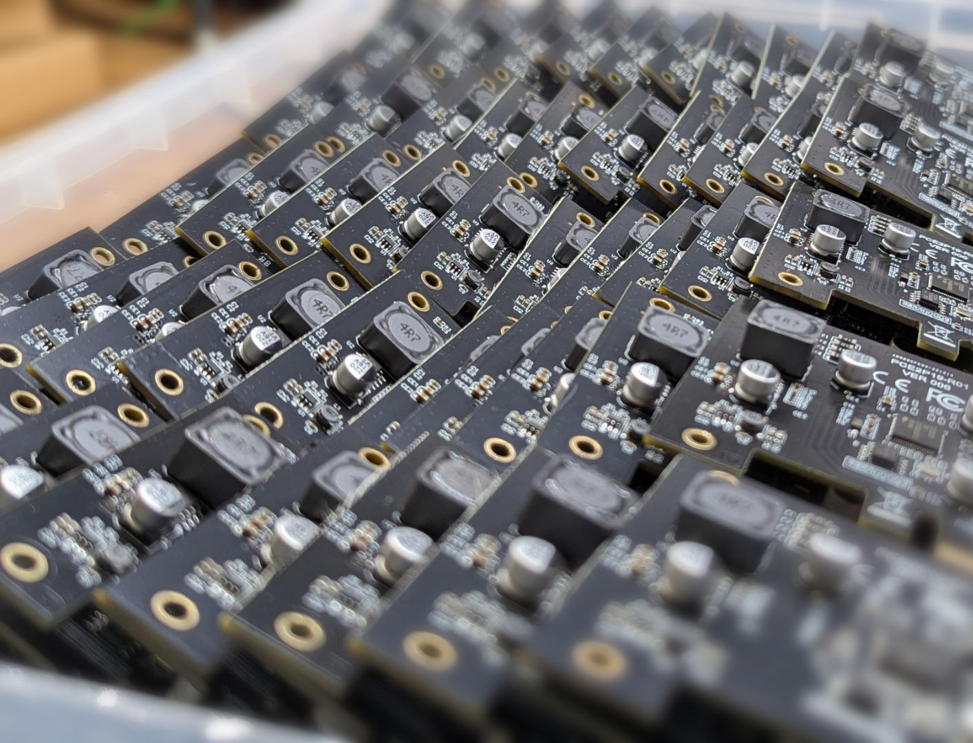 Batch of identical circuit boards representing minimal onboard electronics at scale.